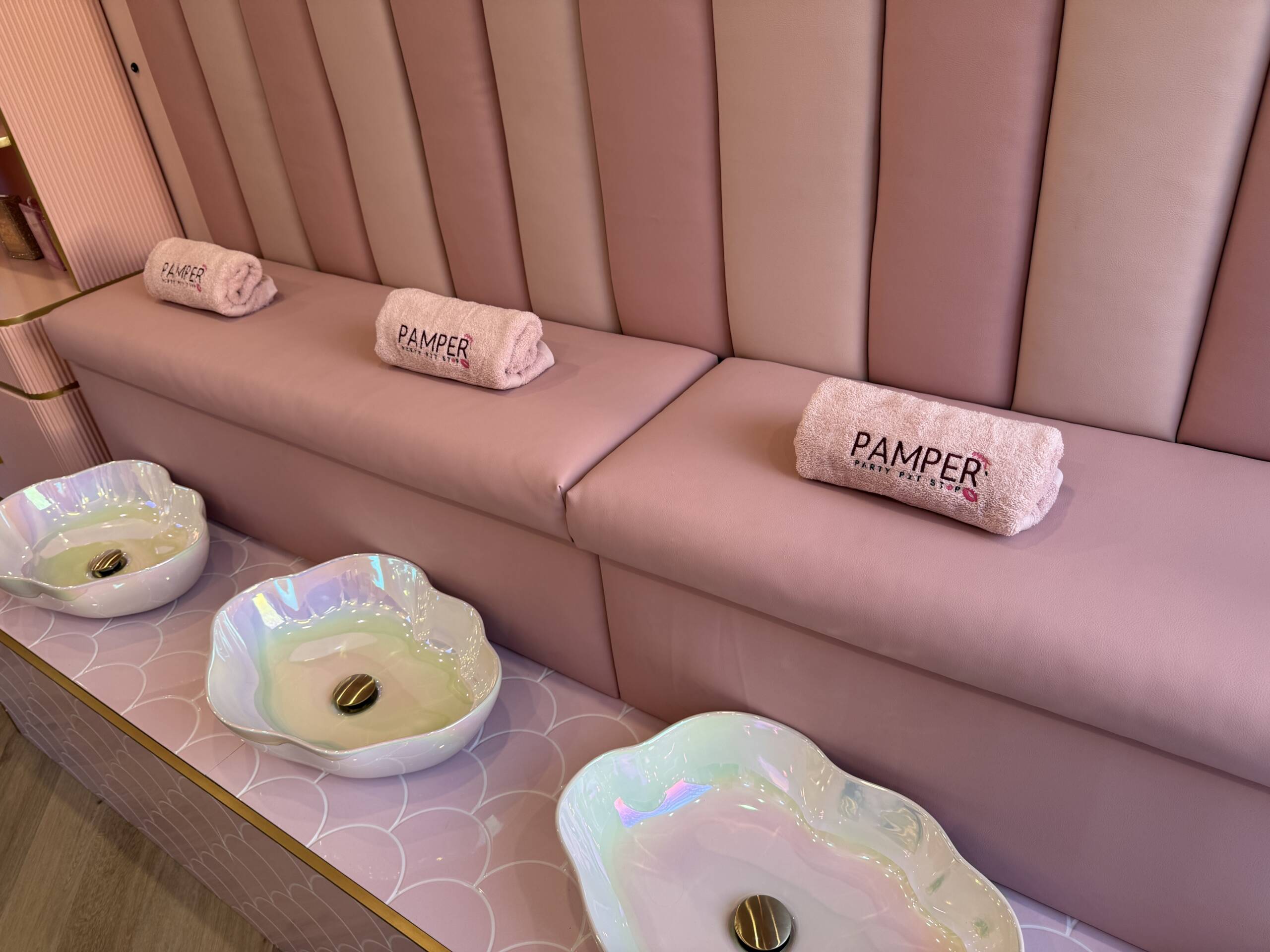 Foot spa bowls and rolled towels ready for pampering